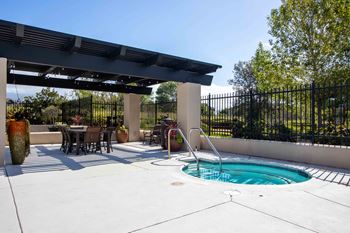 a jacuzzi and patio with a table and chairs
